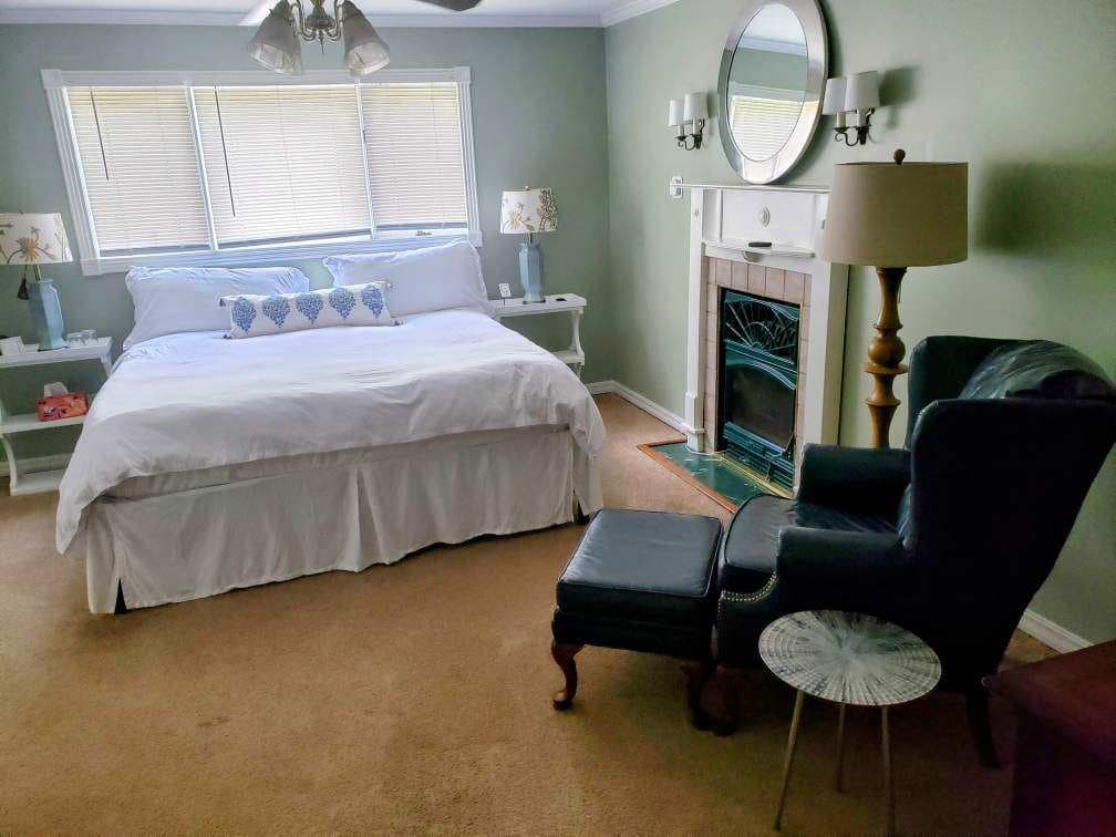 Melville Suite with a king bed, fireplace and leather wingback chair