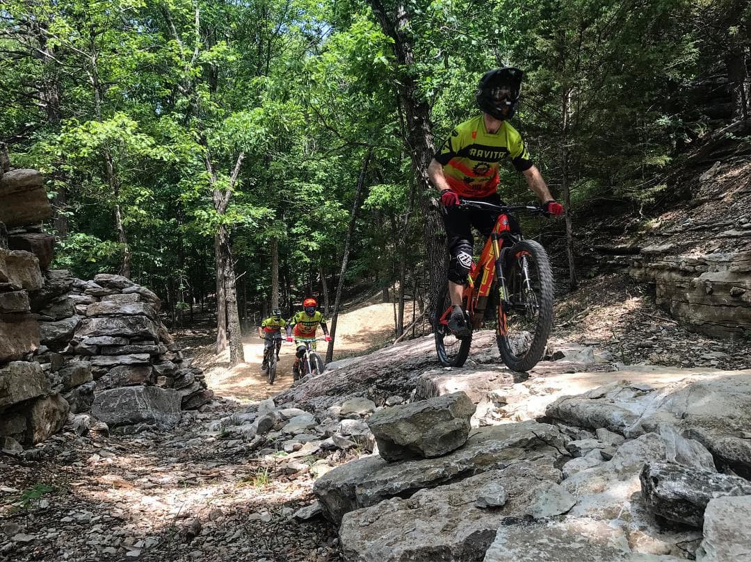 Mountain bikers riding a rocky forest trail in the Ozarks