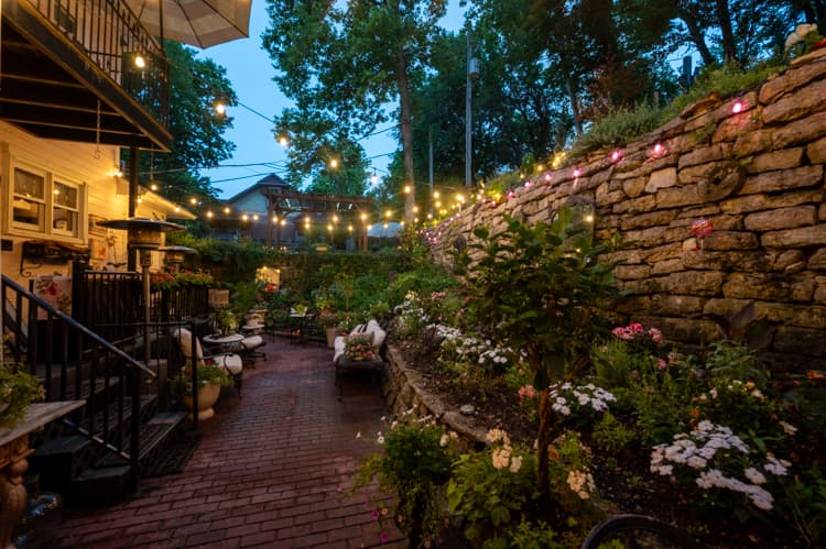 The garden courtyard glowing with string lights at dusk